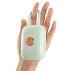 OTOUCH LOUIS vibrator mint green handbag design held in hand showing compact discreet luxury vibrator size