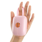 OTOUCH LOUIS vibrator pink handbag design held in hand showing compact portable size and luxury rose gold emblem