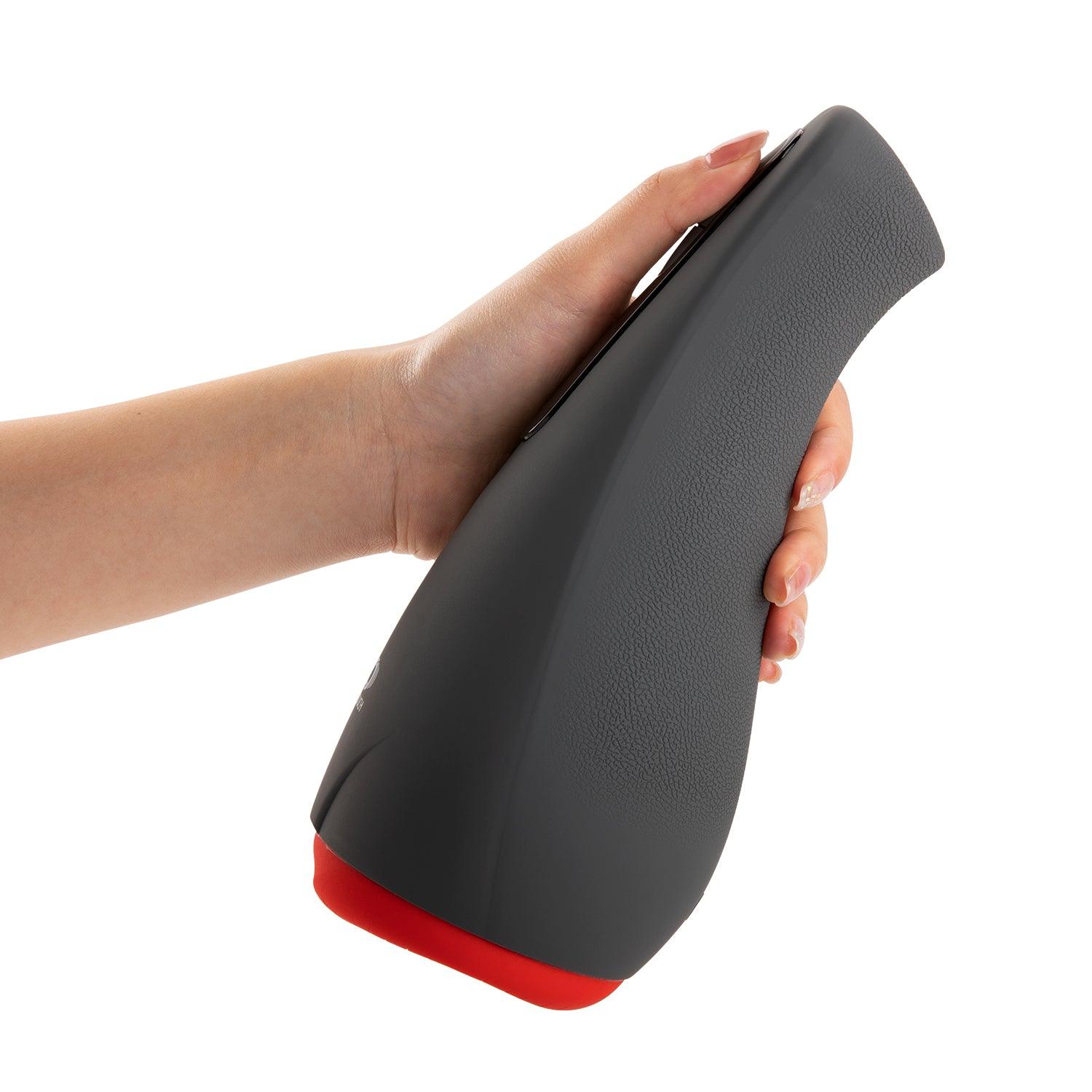 OTOUCH AIRTURN 2 Heating Suction Male Masturbator held in hand showing ergonomic grip and size