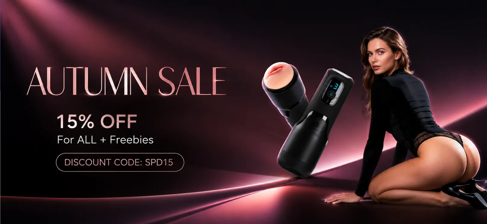 Promotional banner for an 'Autumn Sale' featuring a woman in a black bodysuit kneeling beside a black personal massager, with text reading '15% OFF For ALL + Freebies' and a discount code on a dark pink and purple gradient background.